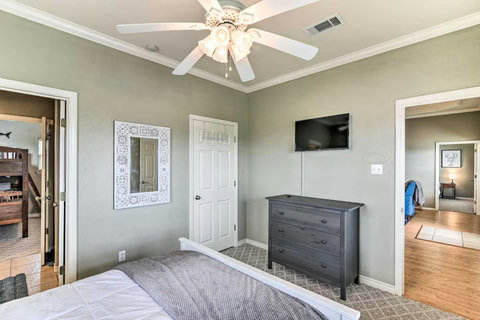 Queen bedroom with a dresser and TV