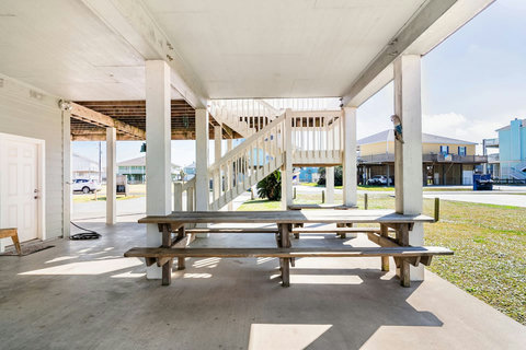 Picnic tables in the shade under the house
