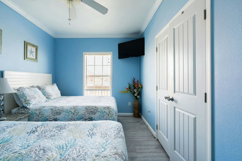 Two-bed room with a closet and TV