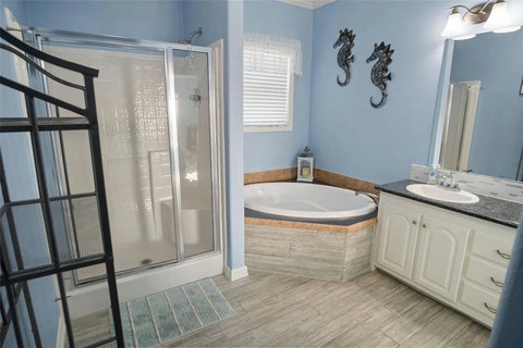 Bath with a separate shower and soaking tub