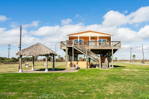 Raised beach house with a palapa on a big open lot