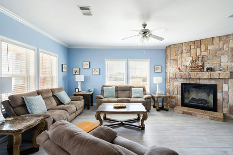 Comfy recliners gathered around the fireplace