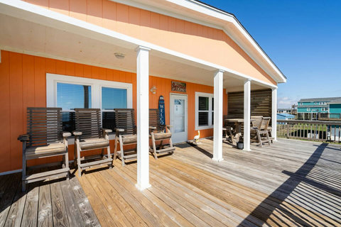 Long covered deck with tall deck chairs