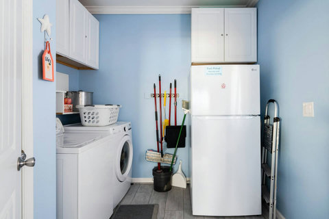 Laundry room with an extra fridge for drinks