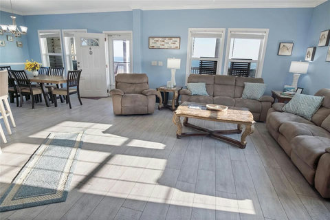 Living area opens to the dining table and front door