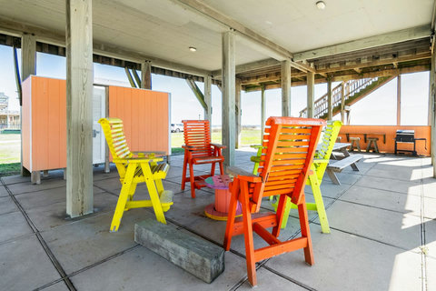 Colorful chairs in the shade under the house