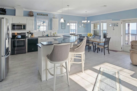 Open kitchen with a large island and stainless appliances
