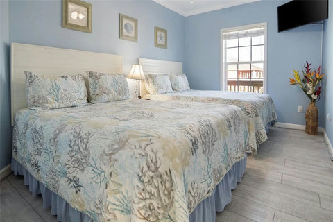 Two beds with coral-print quilts