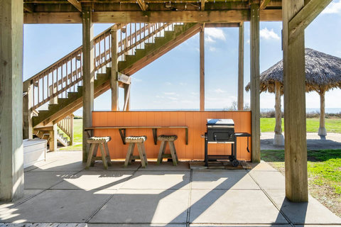 Grill, bar counter and stools under the house