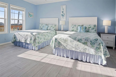Another bedroom with two beds and plenty of light