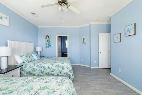 Two-bed room with mermaid art, great for kids or friends