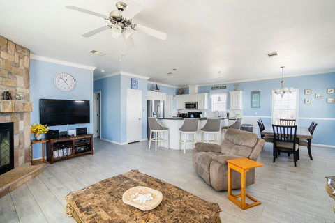 Fireplace and TV with the kitchen just beyond