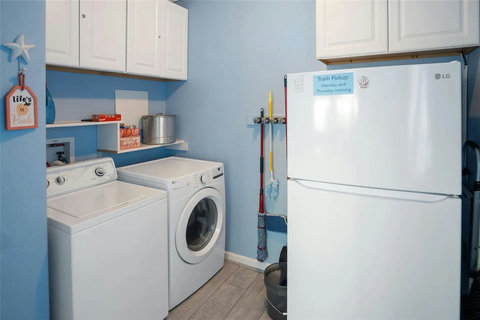 Laundry room with washer, dryer and a second fridge