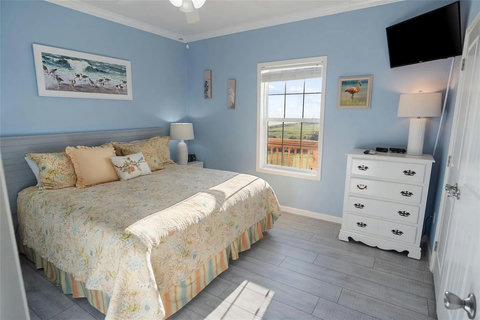 Bedroom with a large bed and a window toward the Gulf