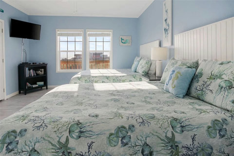 Two beds and a TV in this sunny bedroom