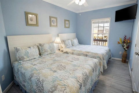 Two-bed room with a wall TV