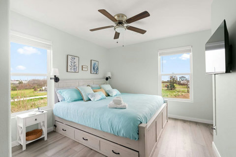 Bedroom with storage drawers and a TV