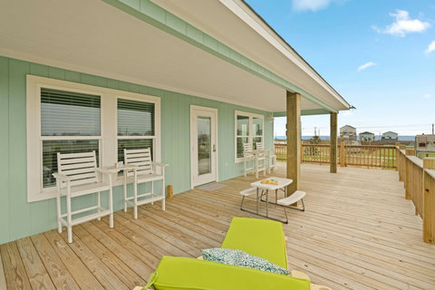 Deck seating with a peek of the Gulf