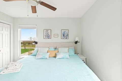Bedroom with a large bed and views of the coast
