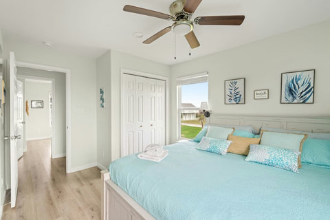 Bedroom with a closet and coastal art