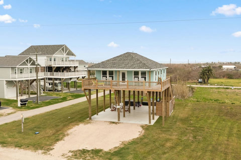 Raised beach house with a covered deck