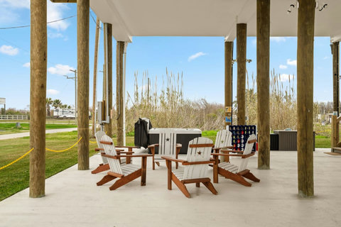 Adirondack chairs in the shade under the house