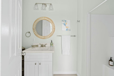 Bath vanity with a round mirror