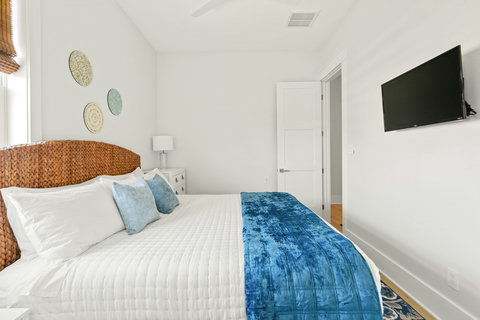 Queen bedroom with a wall TV