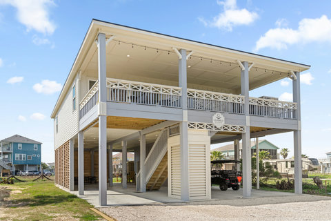 New-build beach house with a long covered deck