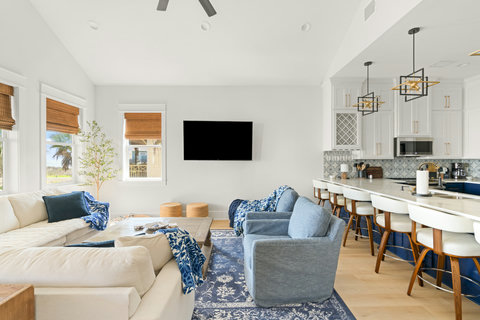 Bright open living room with a big sectional and kitchen bar
