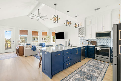 Navy and white kitchen with quartz counters