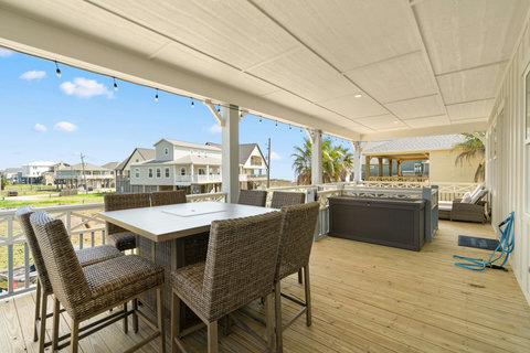 Deck dining and lounge seating under string lights