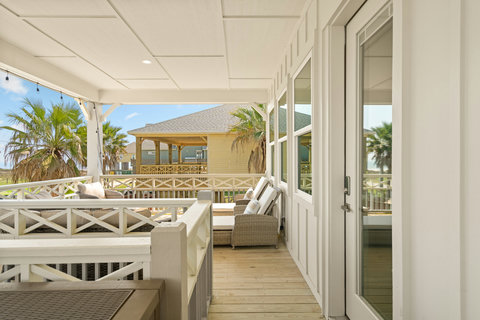 Deck seating with palm trees in view