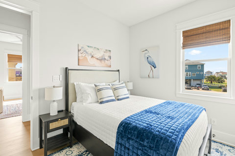 King bed with blue velvet throw