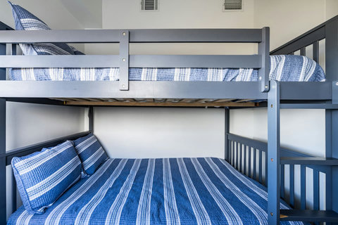 Full-size bunks with striped bedding