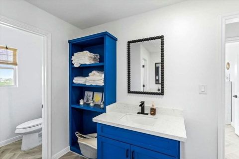 Bath vanity with towel storage