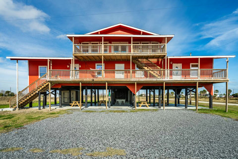 Covered decks on two levels and a gravel drive