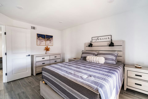 Queen bed with a dresser and closet