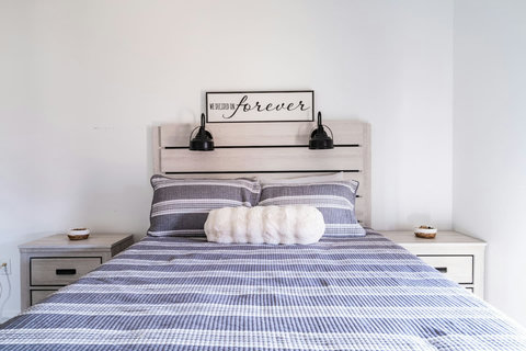 Queen bedroom with soft striped bedding
