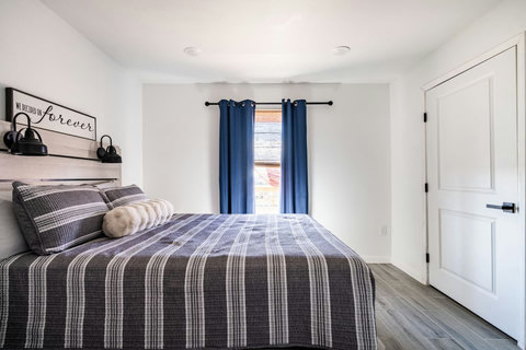 Queen bedroom with blue curtains