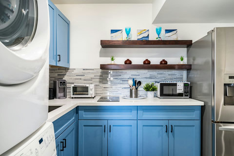 Kitchen with blue cabinets and stainless appliances