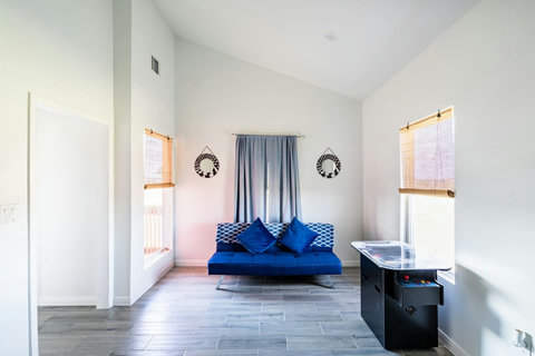 Lounge area with a futon and an arcade table