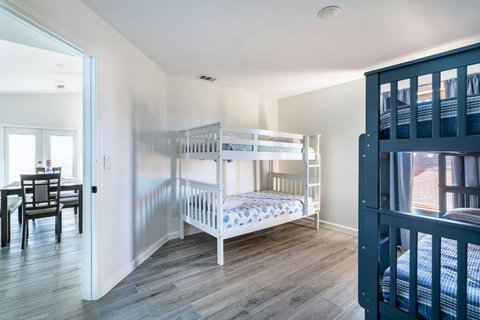 Bunk room with a white bunk bed