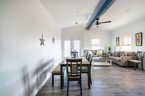 Open living and dining area with vaulted ceilings
