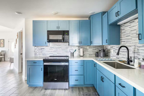 Kitchen with blue cabinets and quartz counters