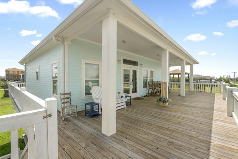 Covered upstairs deck with Adirondack chairs