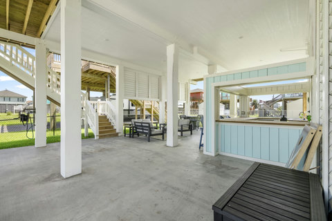 Big shaded patio with the bar and stairs up