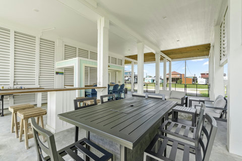 Outdoor dining table and lounge seating in the shade