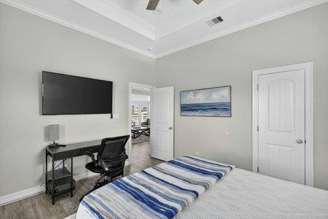 Bedroom with a TV and desk for a little work