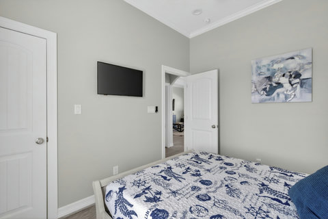 Second bedroom with a wall TV